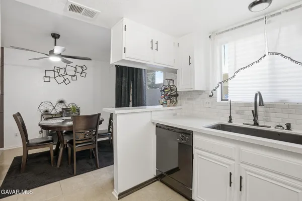 a kitchen with cabinets and chairs in it