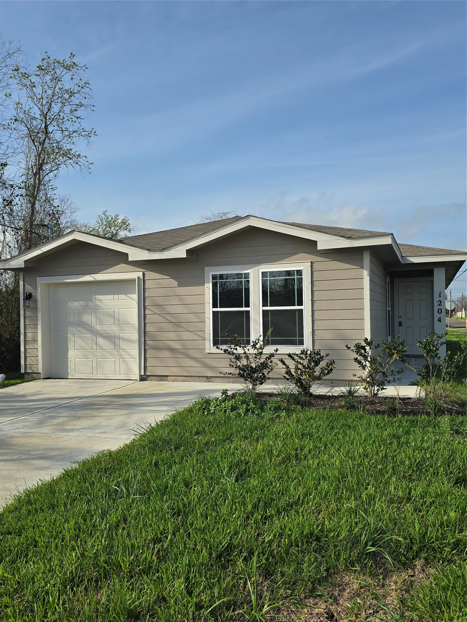 1204 Daniel Street Baytown, TX 77520 - Photo 1 of 11 front view of house with a yard
