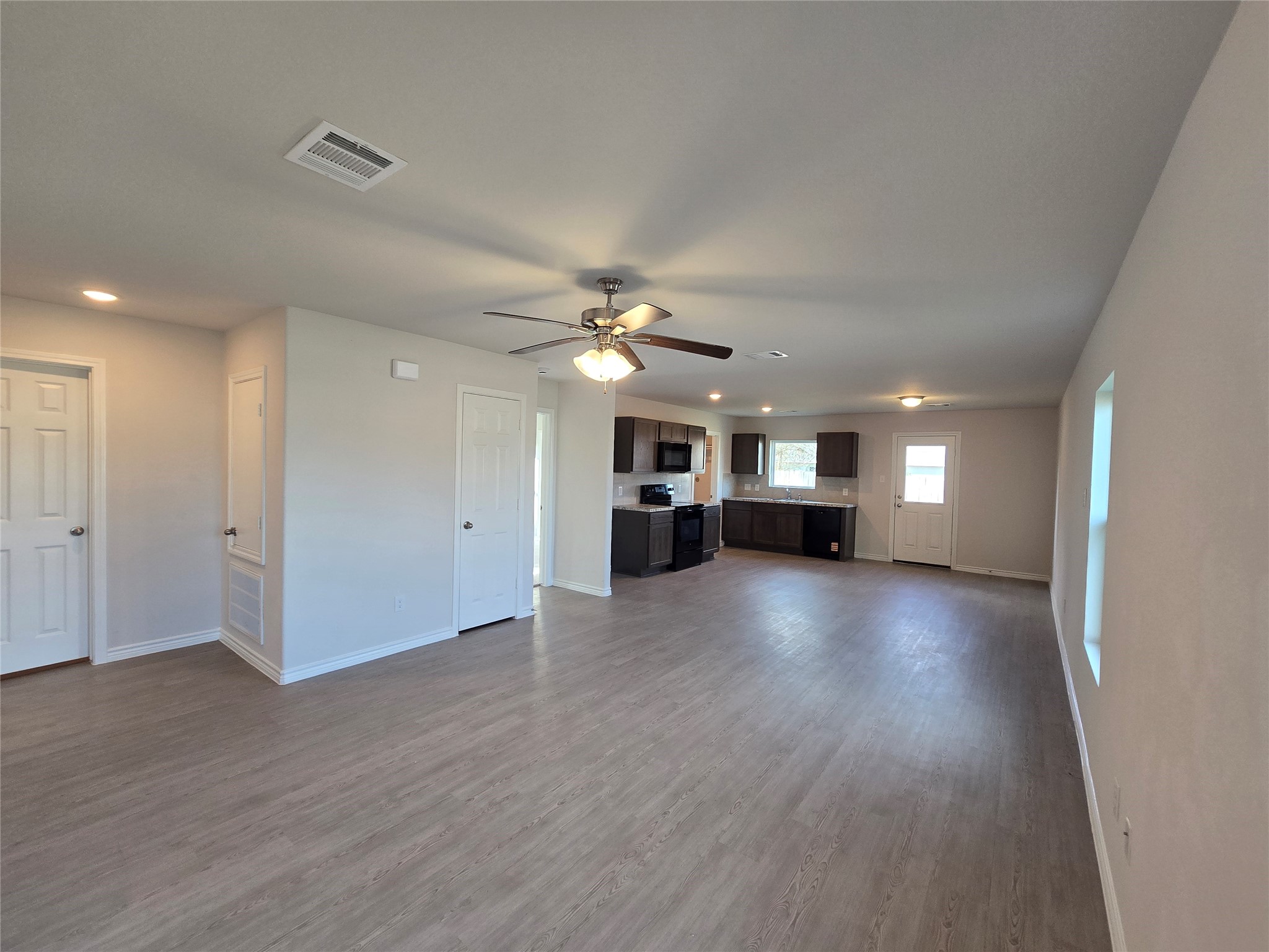 1204 Daniel Street Baytown, TX 77520 - Photo 3 of 11 a view of empty room with wooden floor