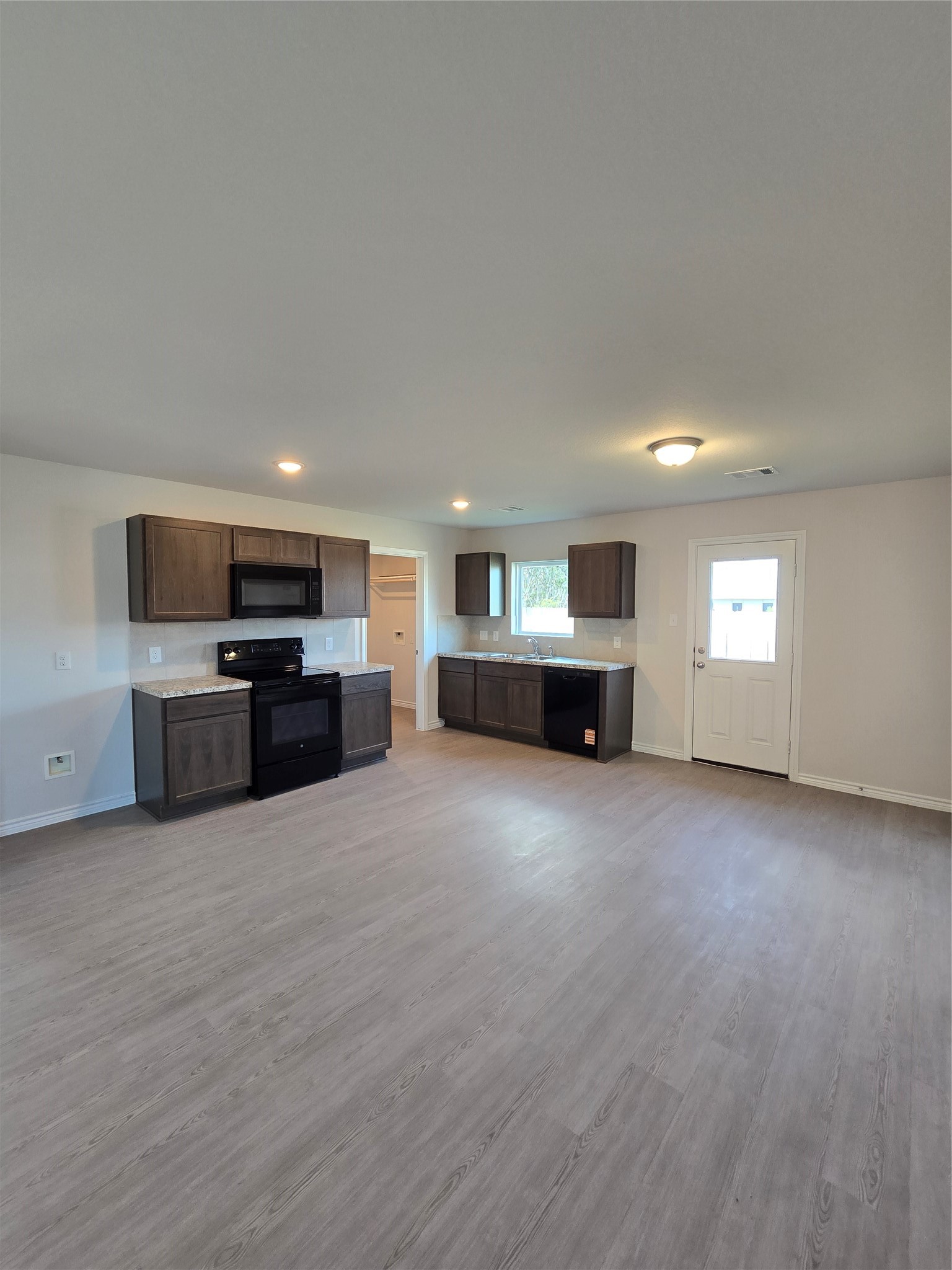 1204 Daniel Street Baytown, TX 77520 - Photo 4 of 11 a view of a kitchen with a stove top oven