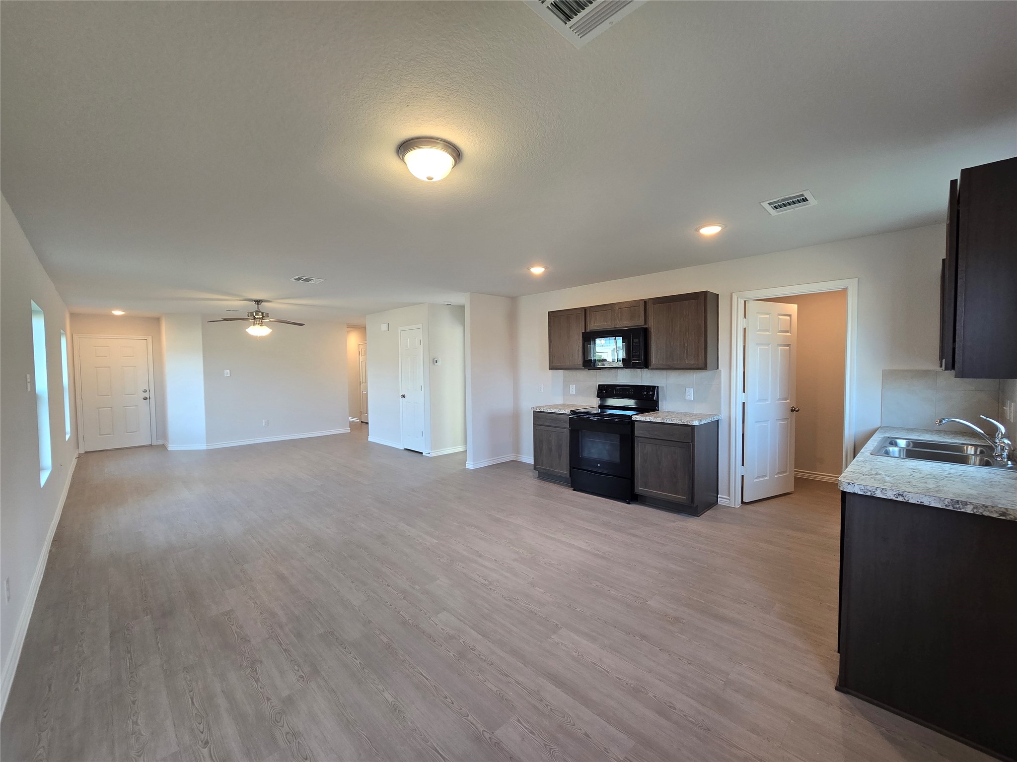 1204 Daniel Street Baytown, TX 77520 - Photo 5 of 11 a view of kitchen with kitchen island granite countertop a sink and refrigerator