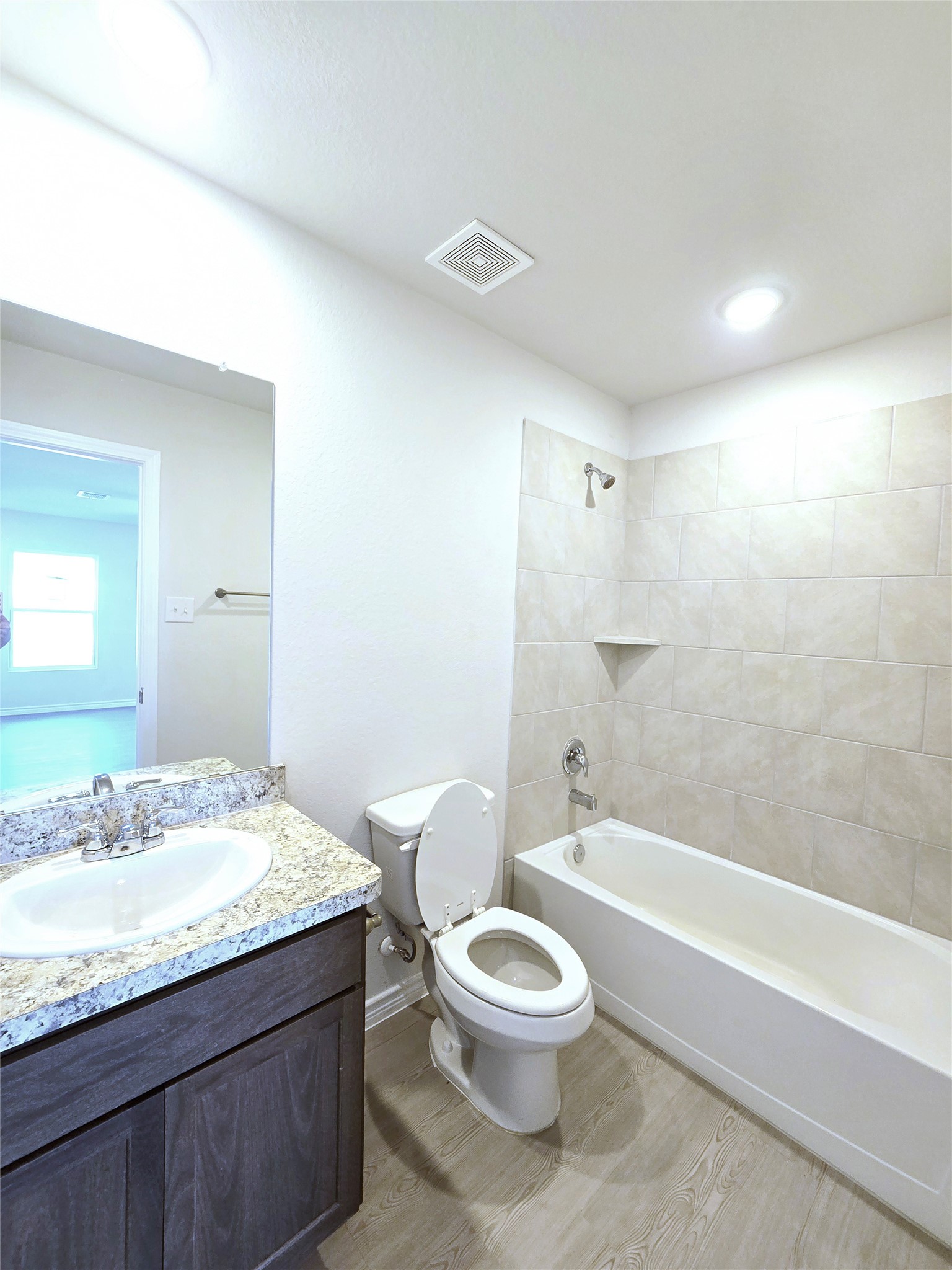 1204 Daniel Street Baytown, TX 77520 - Photo 8 of 11 a bathroom with a granite countertop sink a toilet and shower