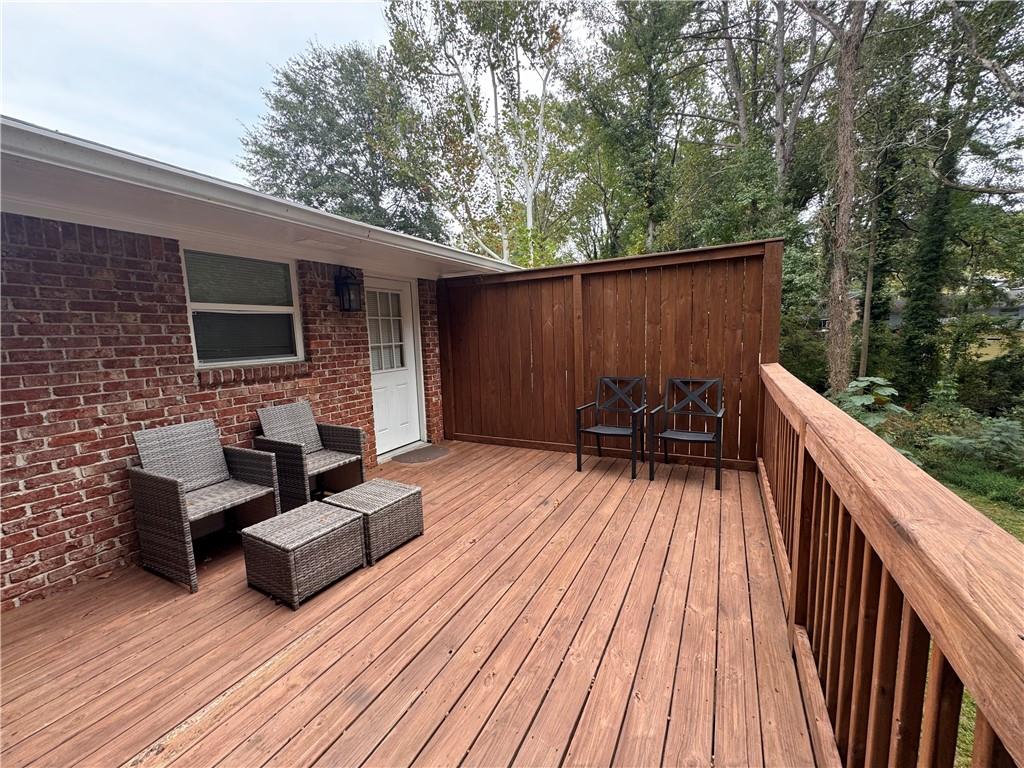 1485 Janmar Drive Decatur, GA 30032 - Photo 13 of 34 a view of deck with table and chairs with wooden floor and fence