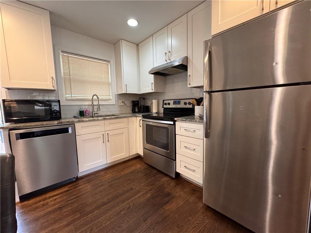1485 Janmar Drive Decatur, GA 30032 - Photo 33 of 34 a kitchen with stainless steel appliances a refrigerator sink and cabinets