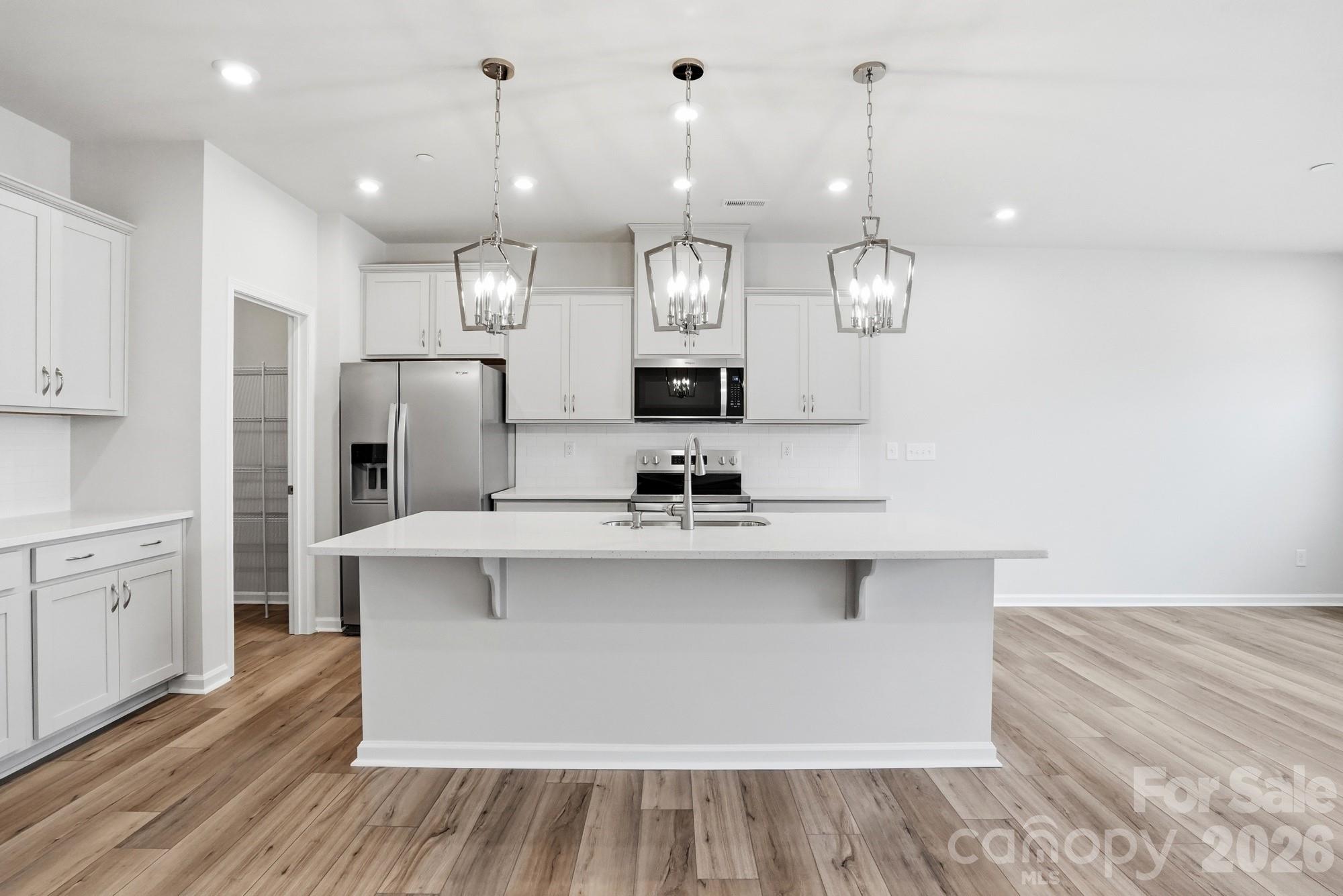 2540 Hedgecliff Road Kannapolis, NC 28083 - Photo 5 of 22 a large kitchen with granite countertop a sink cabinets and stainless steel appliances