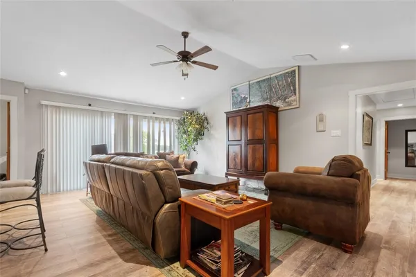 a living room with furniture and a wooden floor
