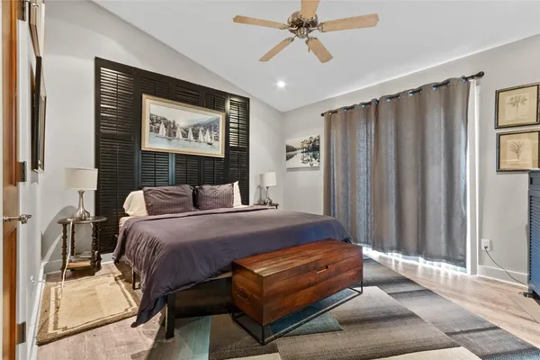 a bedroom with a bed lamp and a window