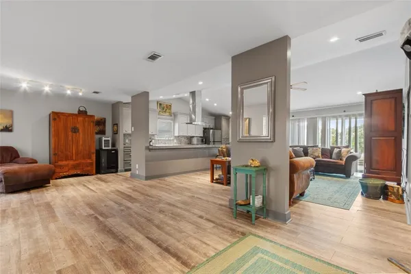 a living room with furniture and kitchen view