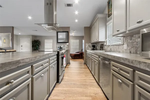 a large kitchen with stainless steel appliances lots of counter space