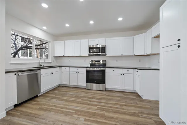 a view of a kitchen counter space and wooden floor