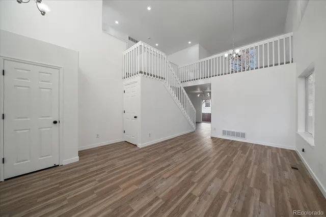 a view of an empty room with a window and fireplace