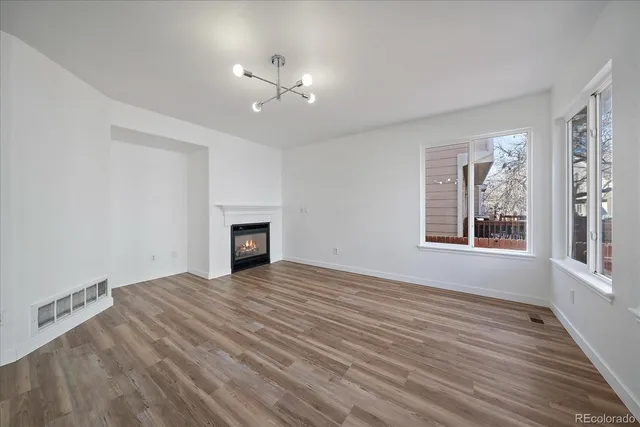 a view of an empty room and fire place