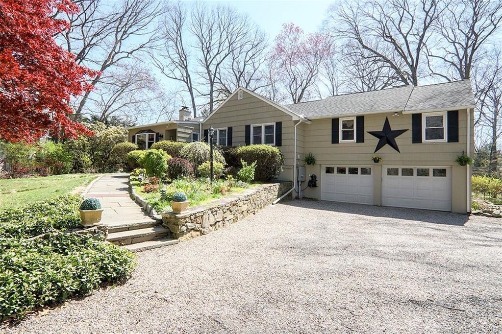 27 Geneva Road Norwalk, CT 06850 - Photo 1 of 1 a front view of a house with a yard and garage