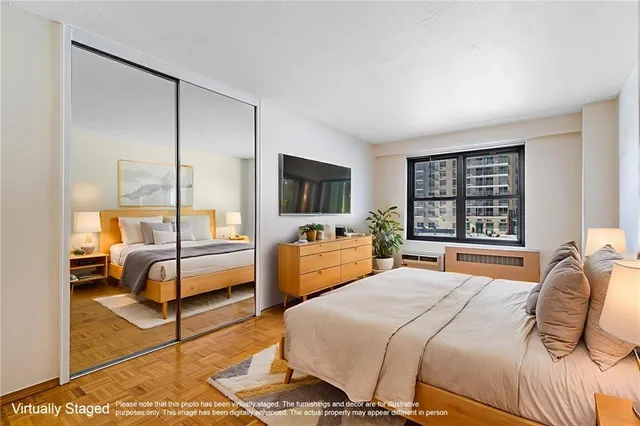 a bedroom with a bed and large windows