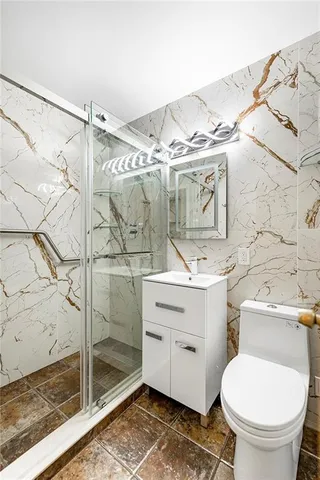 a bathroom with a sink toilet and shower