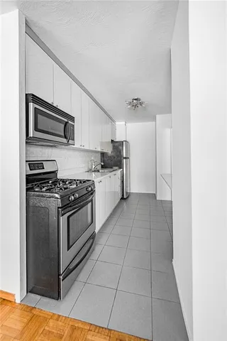 a kitchen with stainless steel appliances granite countertop a stove and a refrigerator