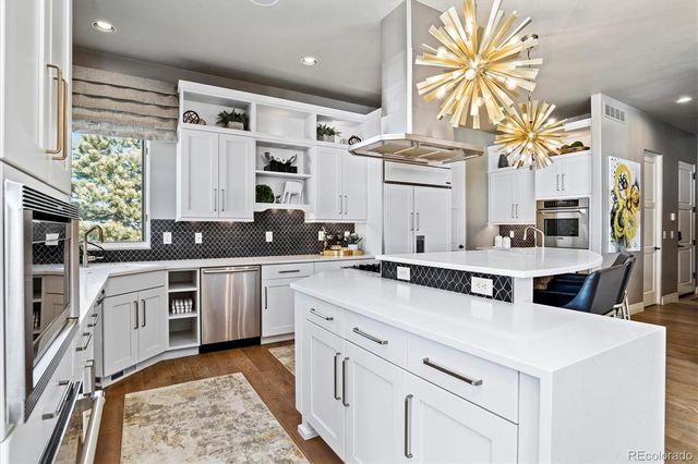 a kitchen with stainless steel appliances a sink stove and cabinets