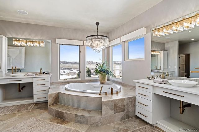 a spacious bathroom with a tub a double vanity sink a mirror and a bathtub