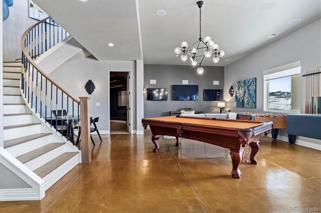 a room with lots of furniture and a chandelier