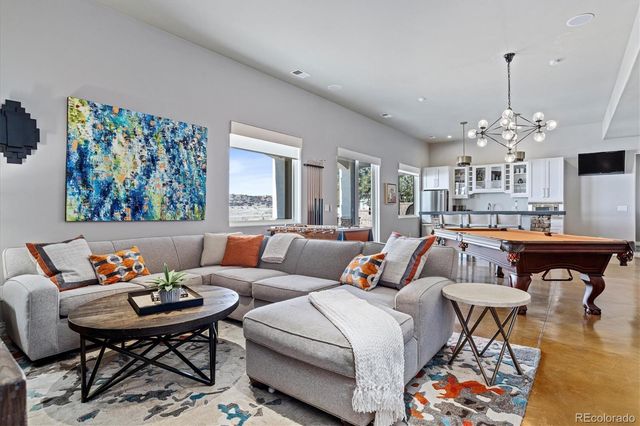 a living room with furniture and a chandelier