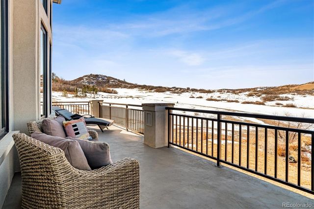 a balcony with furniture and a floor to ceiling window