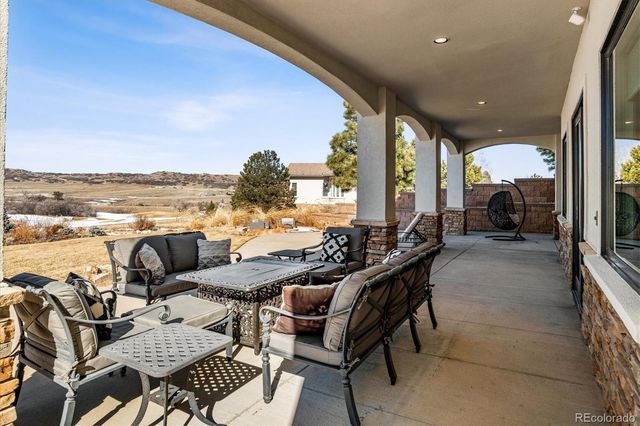 a view of a balcony with chairs and a table