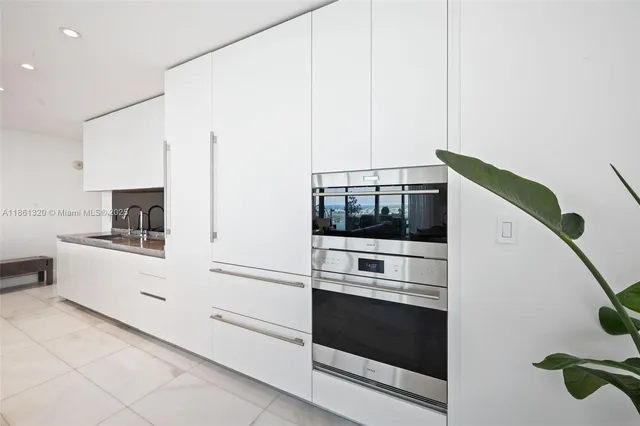 a kitchen with a sink and refrigerator