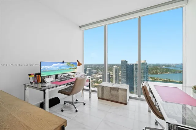 a bedroom with furniture and a floor to ceiling window