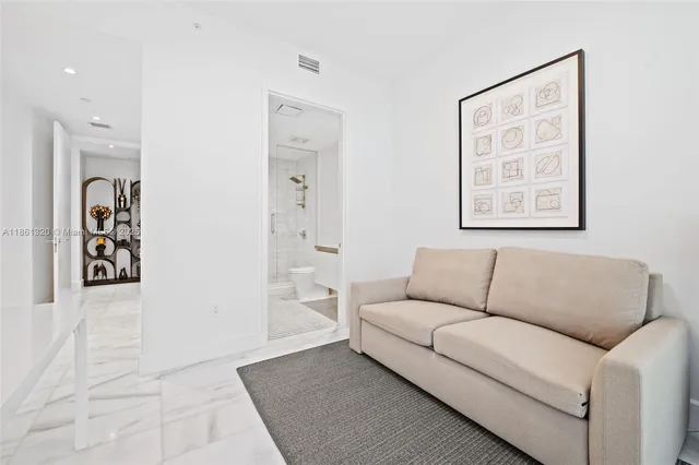 a bathroom with a granite countertop sink mirror and toilet