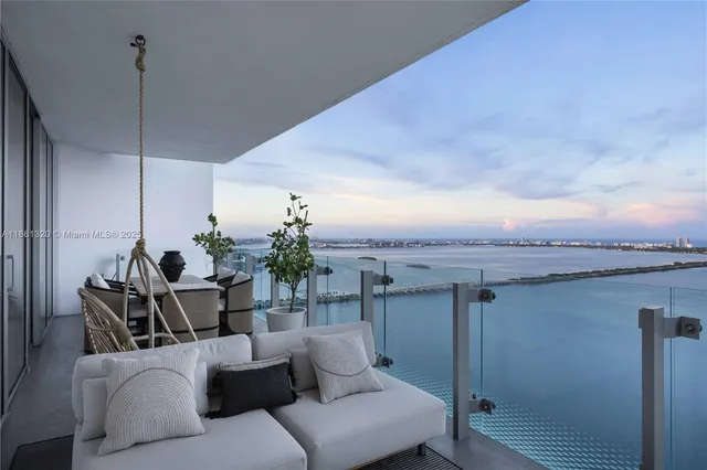 a living room with furniture wooden floor and a potted plant