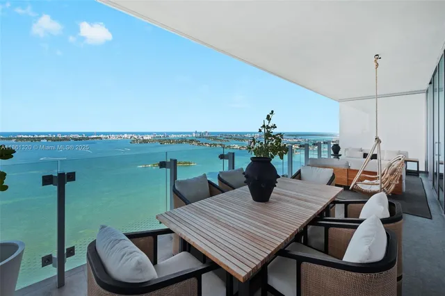 a view of a roof deck with dining table and chairs barbeque oven
