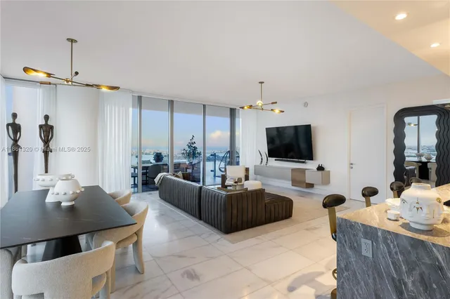 a view of a living room with furniture and floor to ceiling window