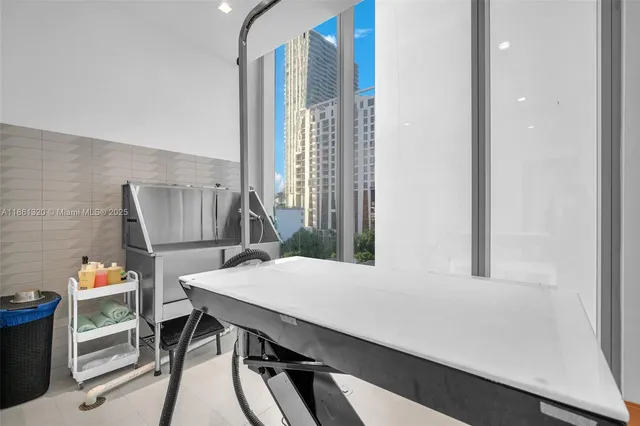 a view of an room with floor to ceiling windows and a chandelier