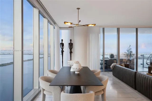 a living room with furniture a flat screen tv and a large window