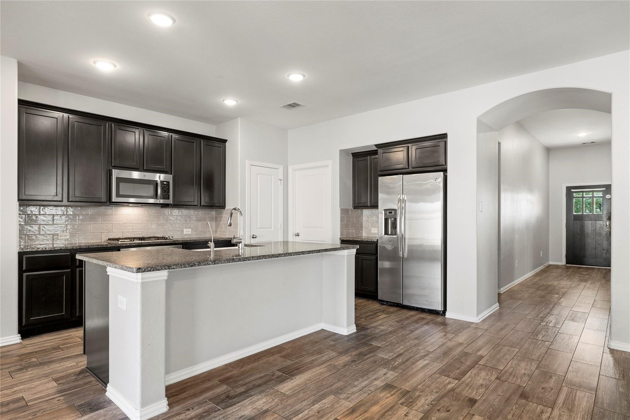 29507 Whitebrush Trace Drive Spring, TX 77386 - Photo 23 of 32 Kitchen with island, breakfast bar, and open view to living area.