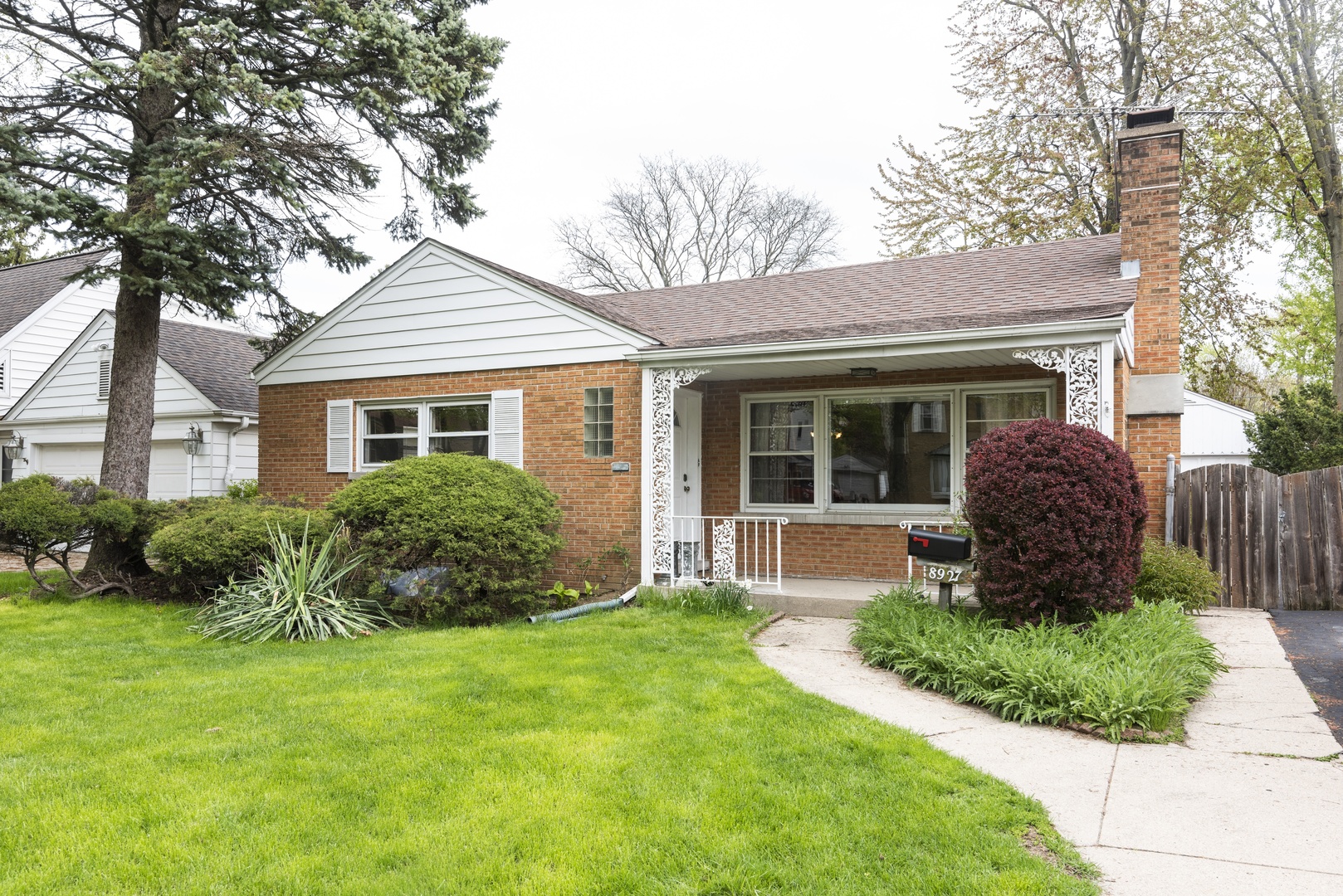 8927 Parkside Avenue Morton Grove, IL 60053 - Photo 1 of 13 a front view of a house with garden and porch