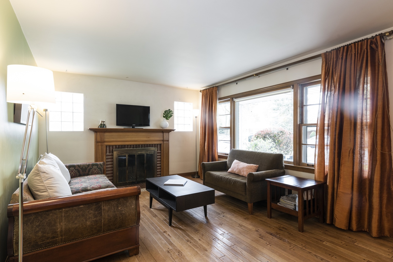 8927 Parkside Avenue Morton Grove, IL 60053 - Photo 2 of 13 a living room with furniture and a fireplace