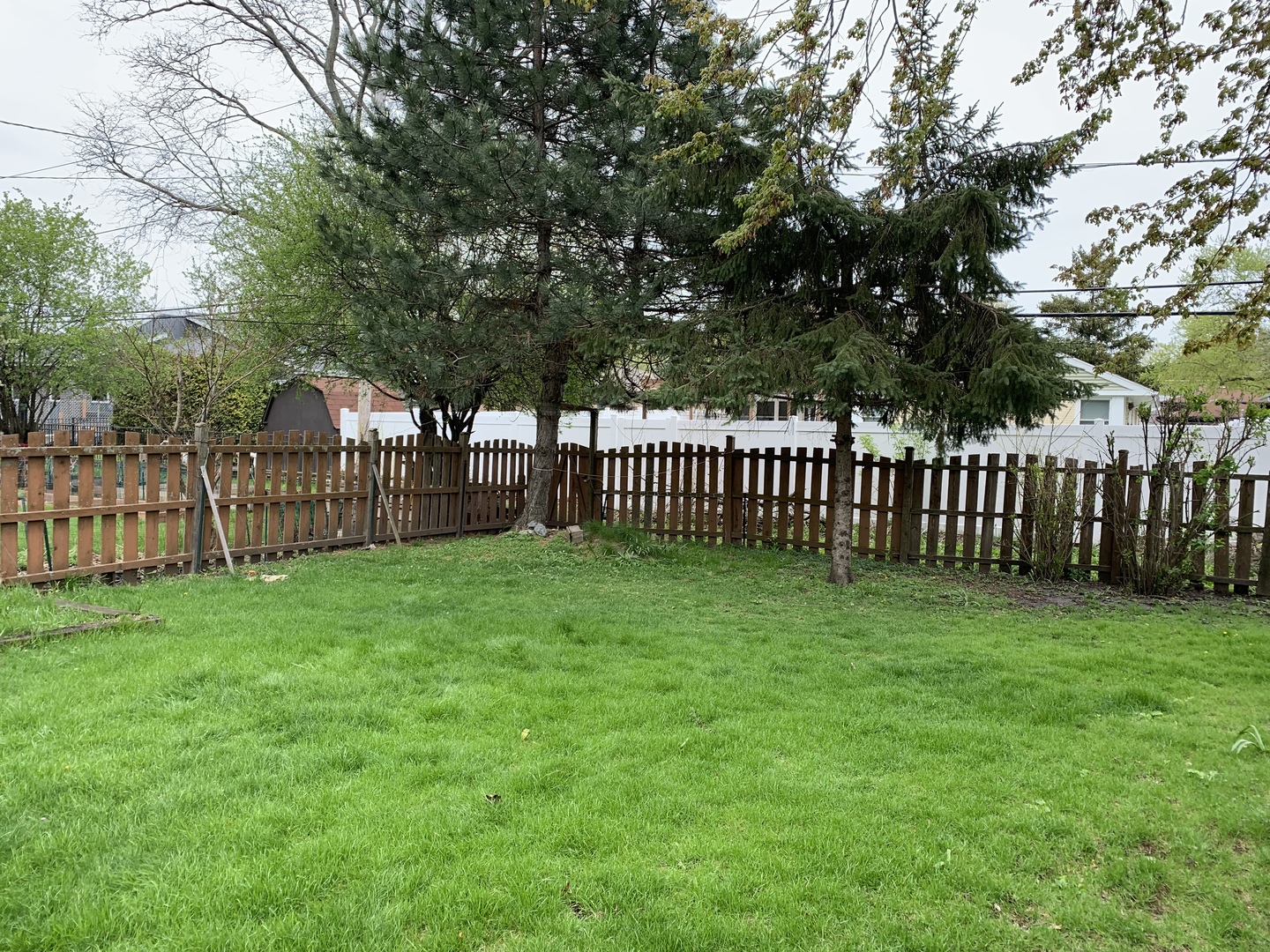 8927 Parkside Avenue Morton Grove, IL 60053 - Photo 13 of 13 a view of a yard with a wooden fence