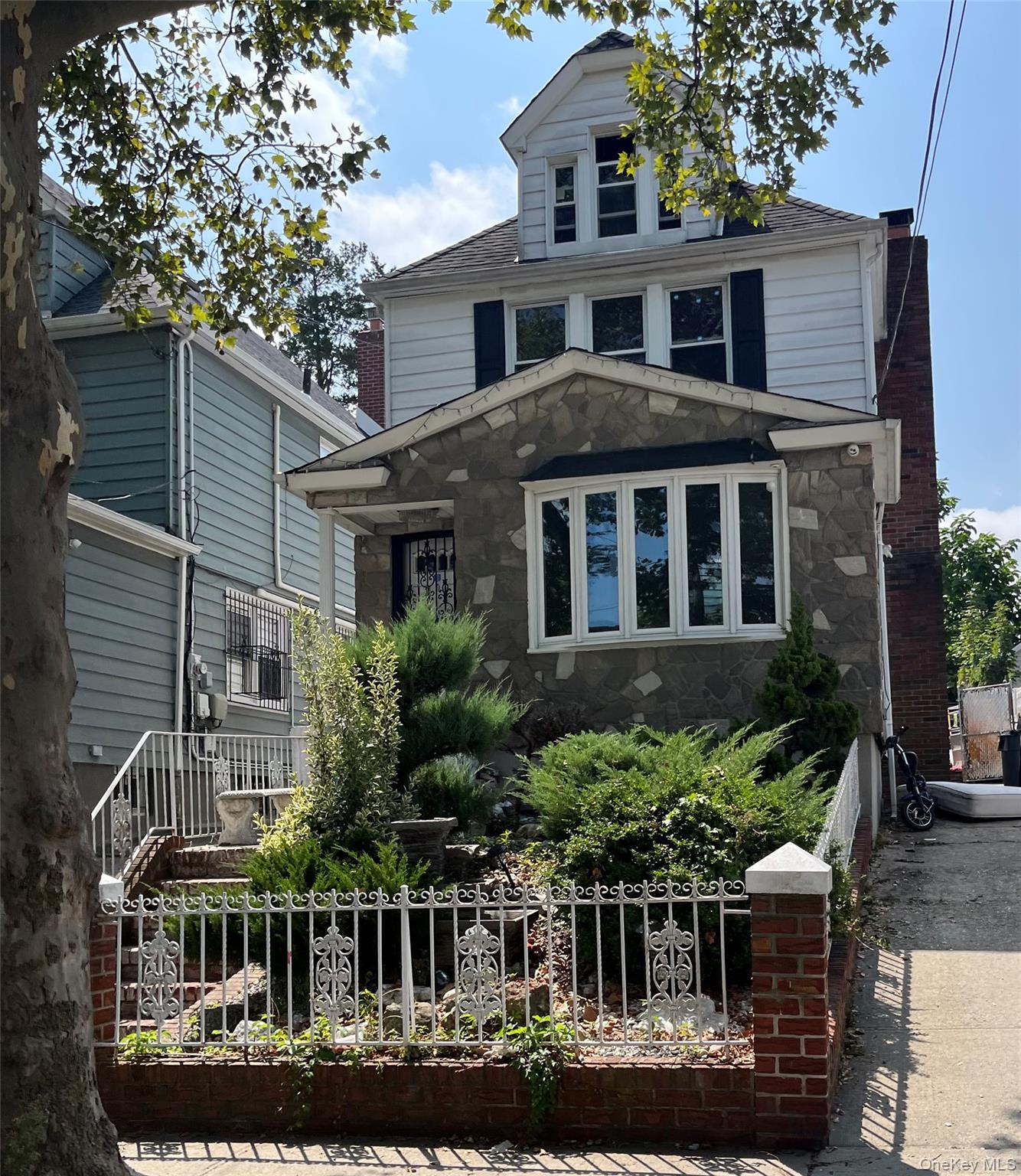 73-32 53rd Road Queens, NY 11378 - Photo 2 of 2 a front view of a house with a yard