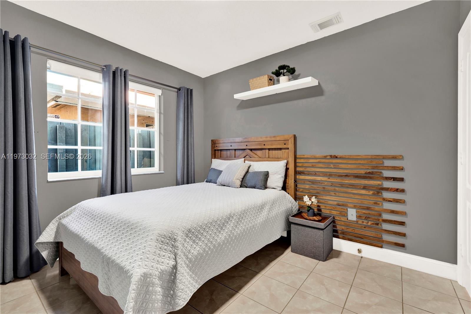 16269 Southwest 78th Terrace Miami, FL 33193 - Photo 22 of 45 a bedroom with a bed and a window