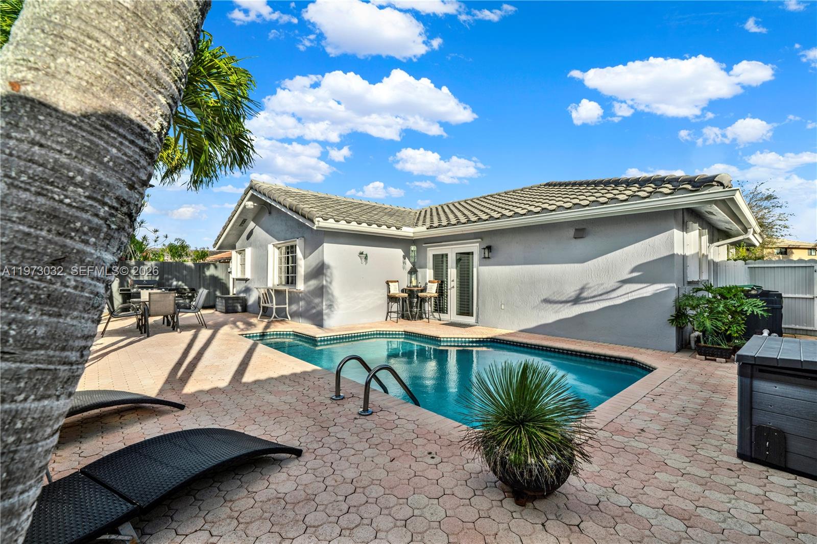 16269 Southwest 78th Terrace Miami, FL 33193 - Photo 30 of 45 a view of a house with pool and chairs