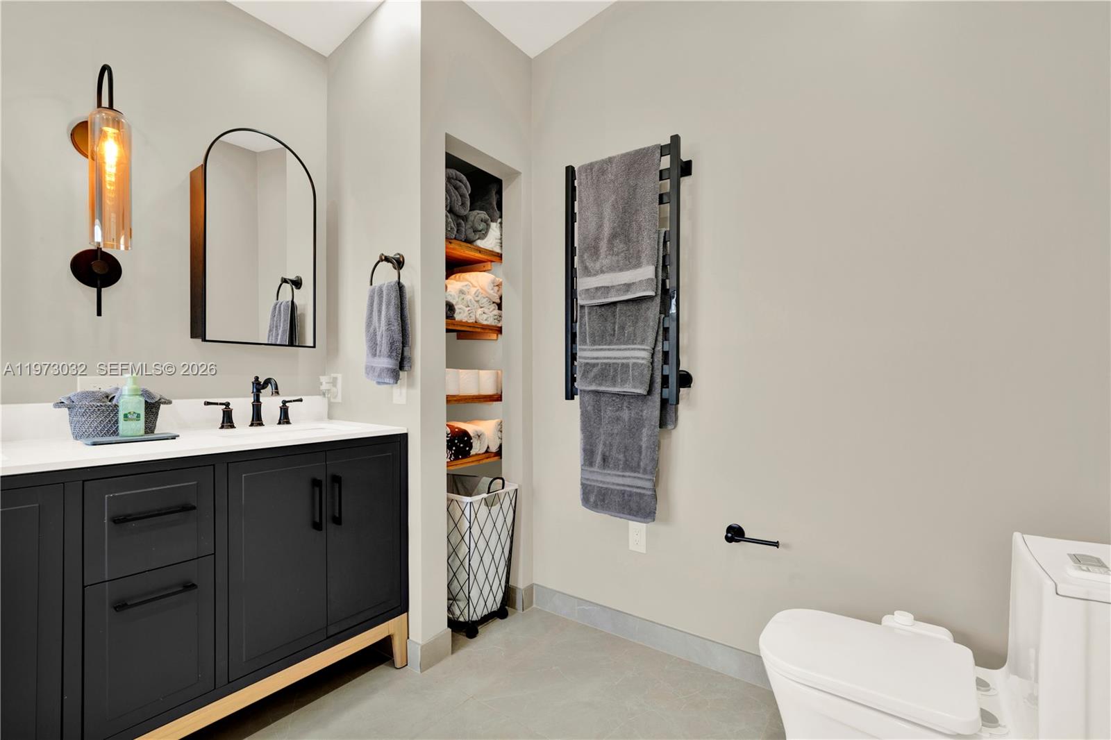 16269 Southwest 78th Terrace Miami, FL 33193 - Photo 7 of 45 a bathroom with a double vanity sink toilet and mirror