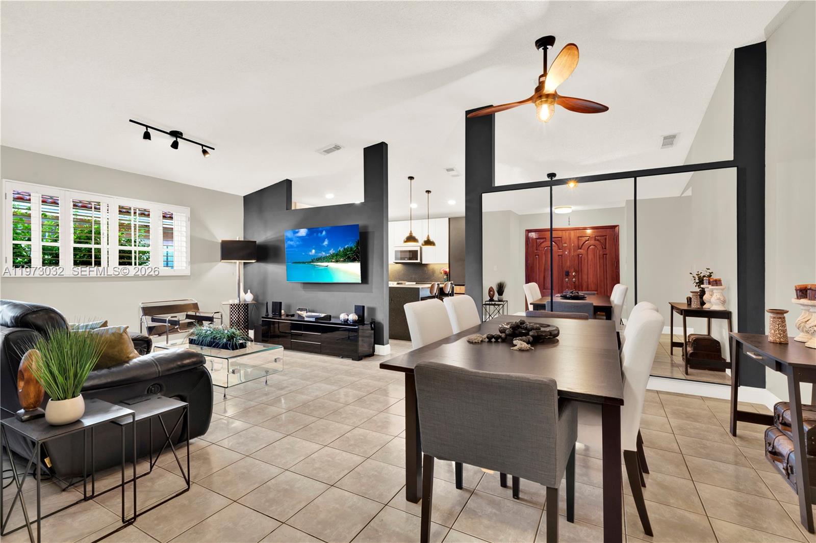 16269 Southwest 78th Terrace Miami, FL 33193 - Photo 10 of 45 a living room with furniture a flat screen tv and a table