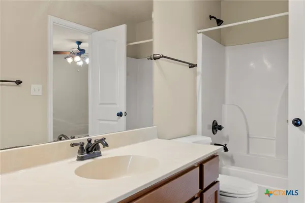 a bathroom with a sink toilet tub and shower