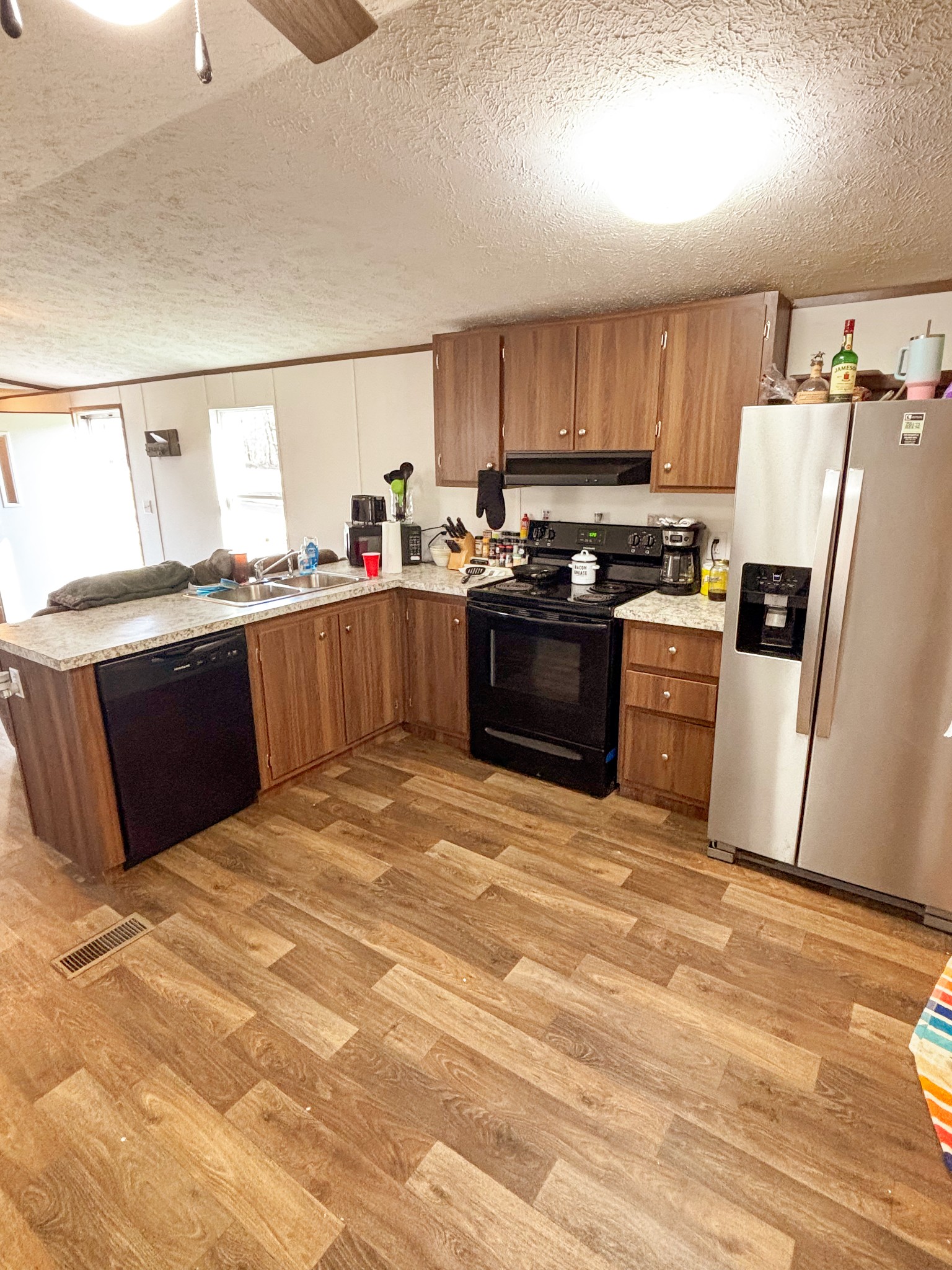 177 Quail Hollow Road Summertown, TN 38483 - Photo 8 of 15 a kitchen with stainless steel appliances kitchen island granite countertop a refrigerator stove and sink