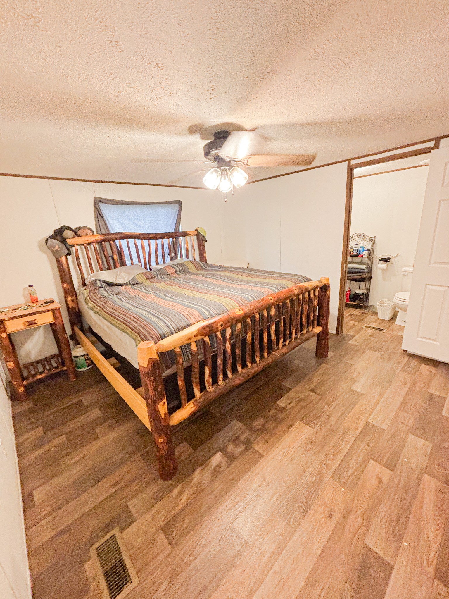 177 Quail Hollow Road Summertown, TN 38483 - Photo 10 of 15 a bedroom with a bed and a chandelier
