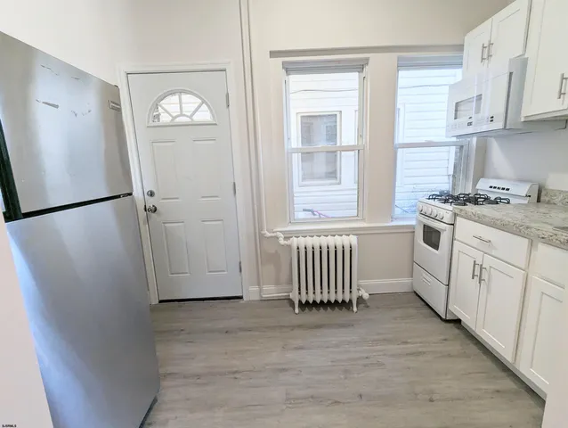 a view of walk in closet with wooden floor