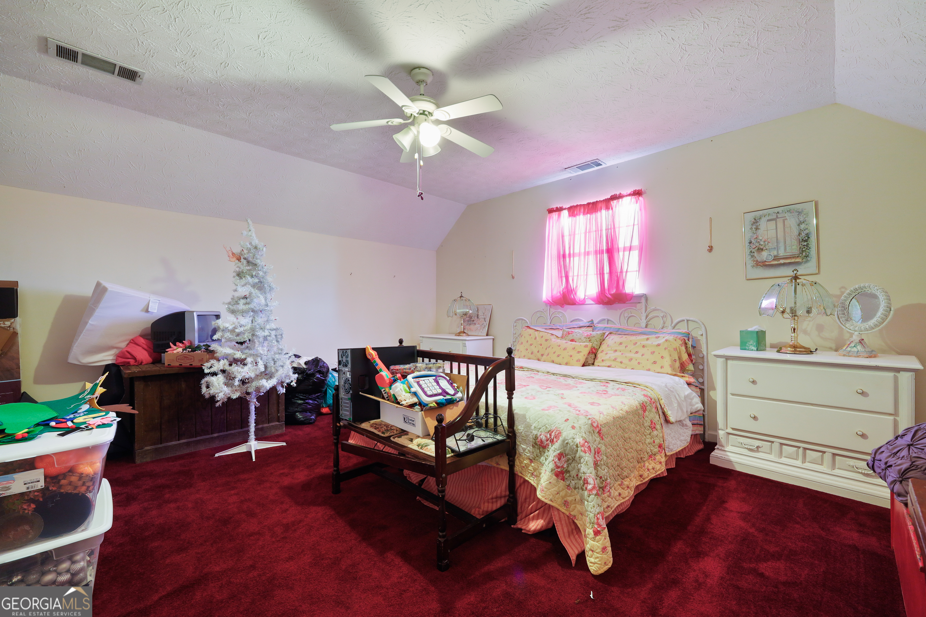 2433 Bear Creek Road Statham, GA 30666 - Photo 25 of 58 a bed room with a bed and a chandelier
