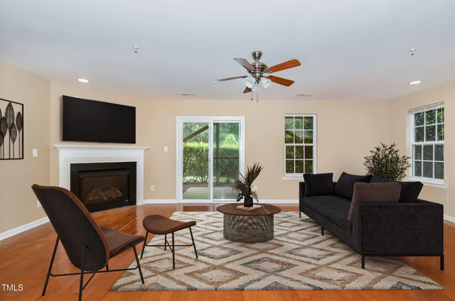 a living room with furniture a fireplace and a flat screen tv