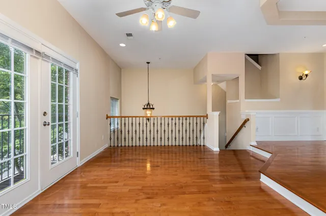 a view of a livingroom with a ceiling fan and window